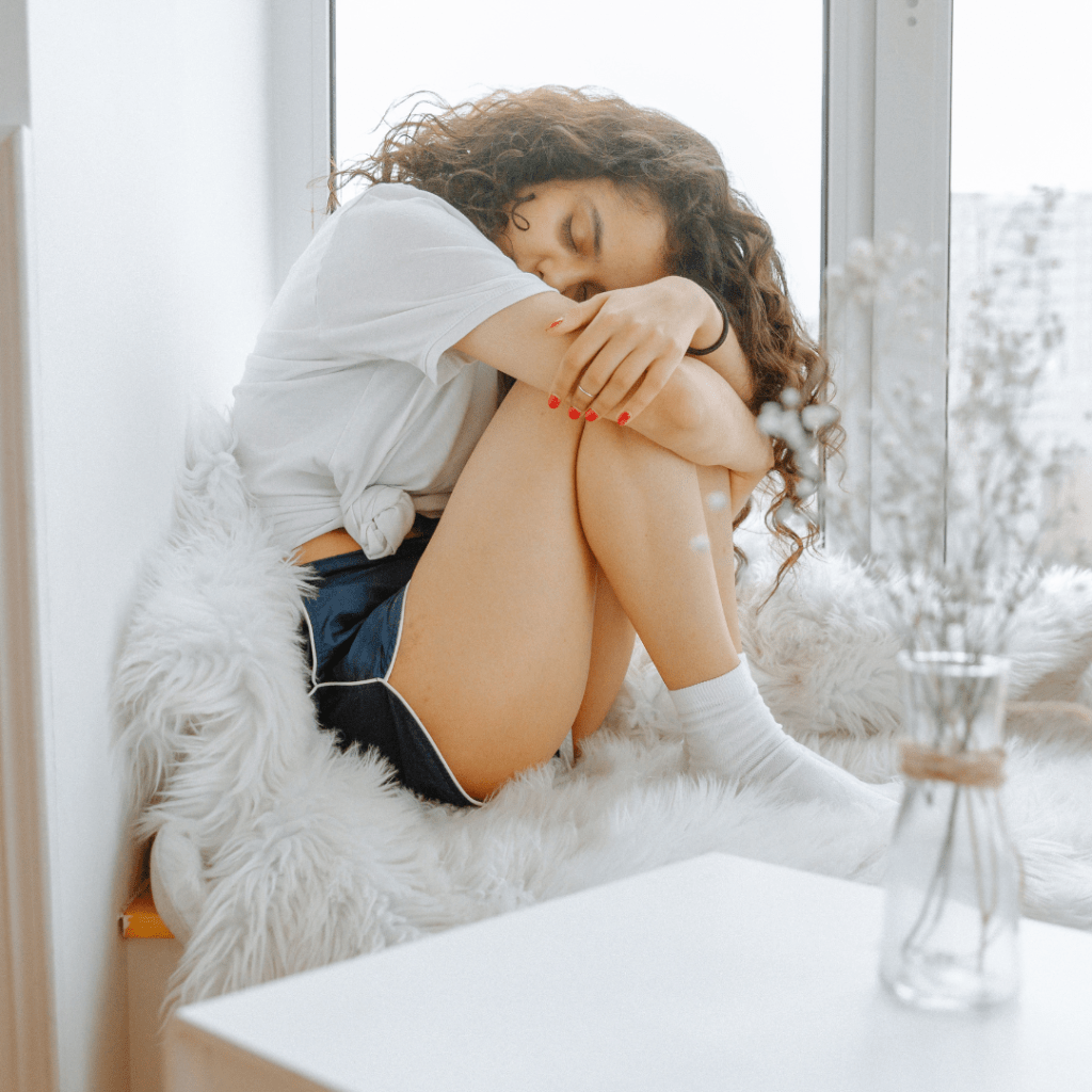 Woman feeling emotional and in pain during menstruation.