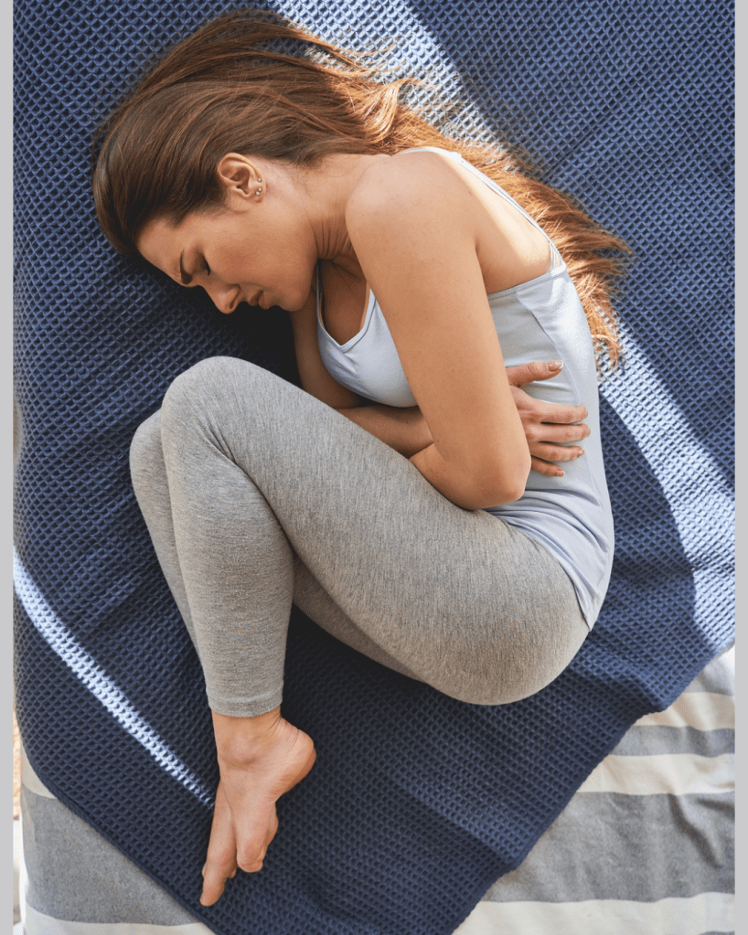 Woman experiencing severe menstrual cramping.